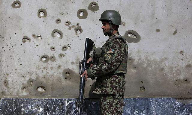 Afghan National Army soldier keeps watch near the site of an attack in Kabul