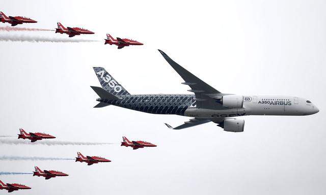 FILE PHOTO: An Airbus A350 aircraft flies in formation with Britain's Red Arrows flying display team at the Farnborough International Airshow in Farnborough