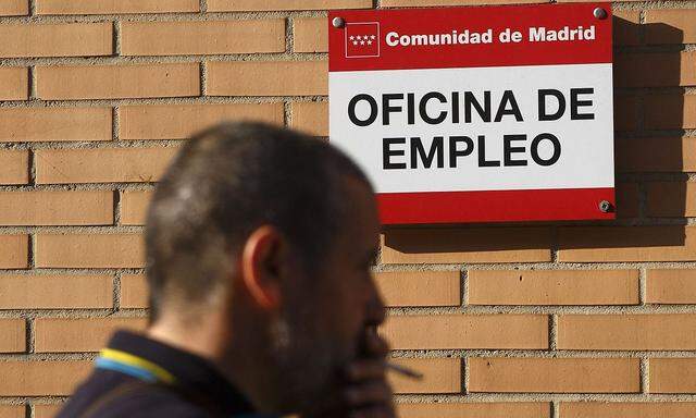 A man stands in front of a government-run employment office in Madrid