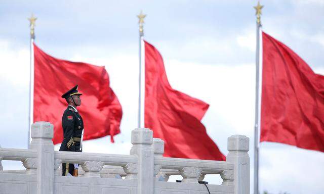 A soldier stands guard during a tribute ceremony in front of the Monument to the People's Heroes at Tiananmen Square in Beijing