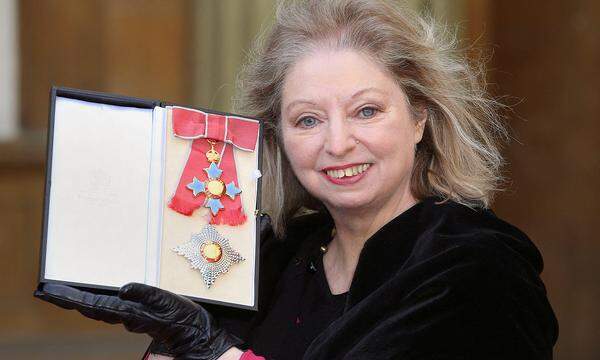 FILE PHOTO: Author Hilary Mantel poses with her Commander of the British Empire award at Buckingham Palace in London