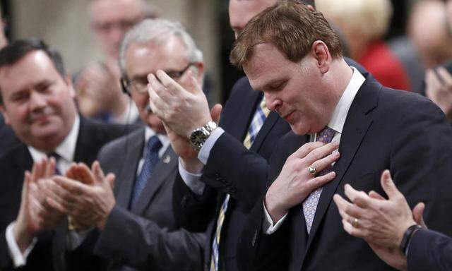 Canada´s Foreign Minister Baird receives a standing ovation before announcing his resignation in the House of Commons in Ottawa