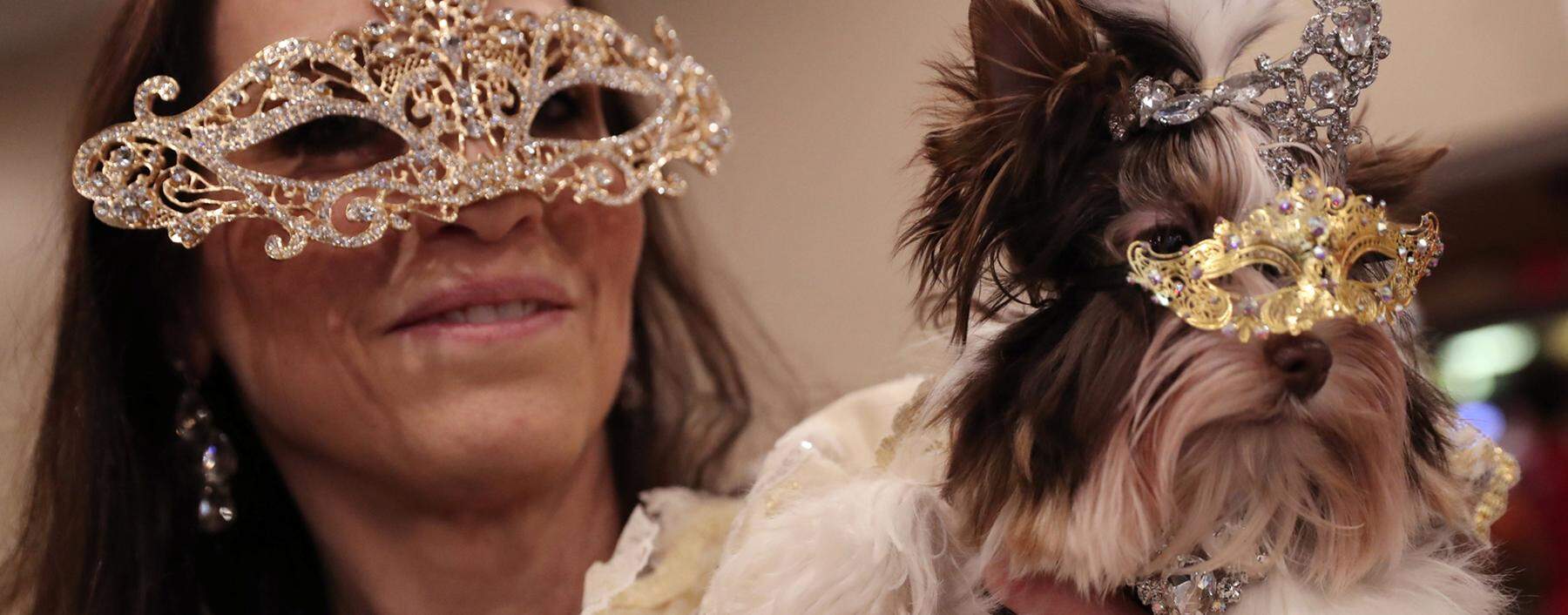 A woman holds a dog backstage at the 16th annual New York Pet fashion show in New York