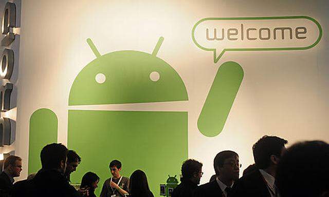 Participants gather around the Google Android stand at the Mobile World Congress in Barcelona, Spain,
