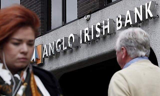 Pedestrians walk past a branch of Anglo Irish Bank in Dublin