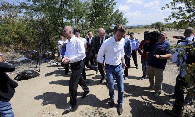 Macedonian Interior Minister Cavkov walks next to Austrian Foreign Minister Kurz at the Greek-Macedonian border line, near Gevgelija, in Macedonia