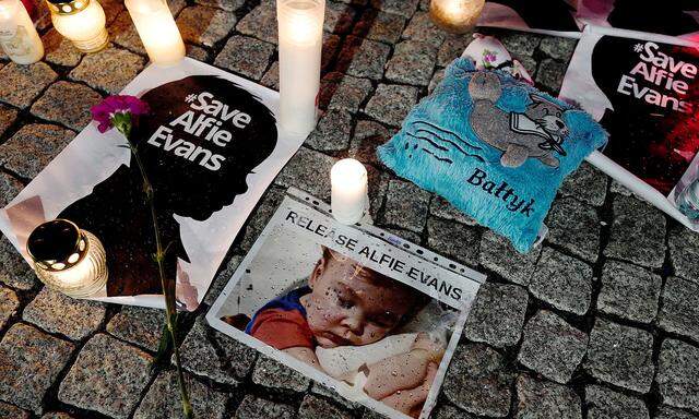 FILE PHOTO:  Candles and placards are pictured during a protest in support of Alfie Evans, in front of the British Embassy building in Warsaw