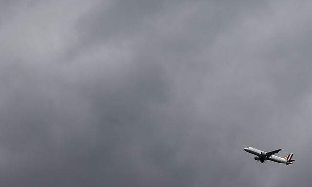 Germanwings aircraft takes off from Cologne-Bonn airport in front of dark clouds 