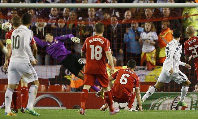 Real Madrid's Cristiano Ronaldo scores the opening goal against Liverpool during their Champions League Group B soccer match at Anfield in Liverpoo