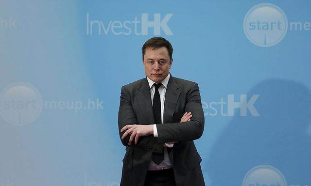 Tesla Chief Executive Elon Musk stands on the podium as he attends a forum on startups in Hong Kong