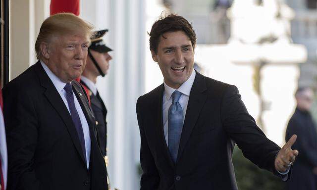 U S President Donald Trump greets Canada s Prime Minister Justin Trudeau on a windy day to the West