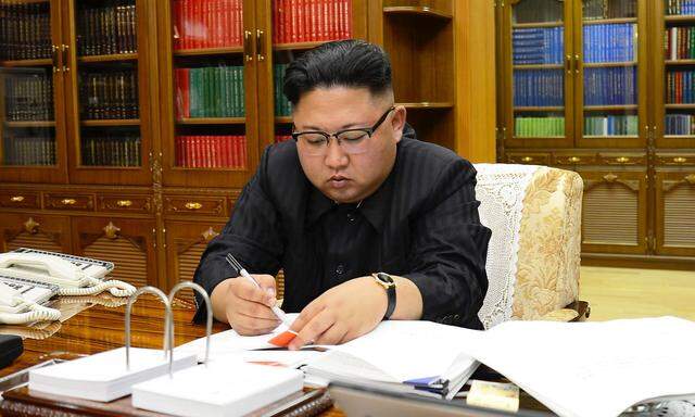 North Korean Leader Kim Jong Un signs the order to carry out the test-fire of inter-continental ballistic rocket Hwasong-14 in this undated photo released by North Korea's Korean Central News Agency (KCNA) in Pyongyang
