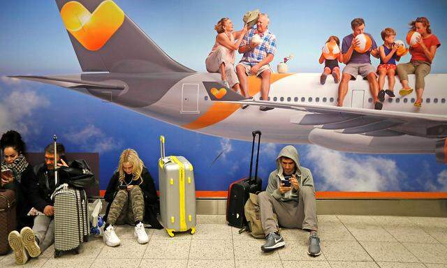 Passengers wait around in the South Terminal building at Gatwick Airport after drones flying illegally over the airfield forced the closure of the airport, in Gatwick