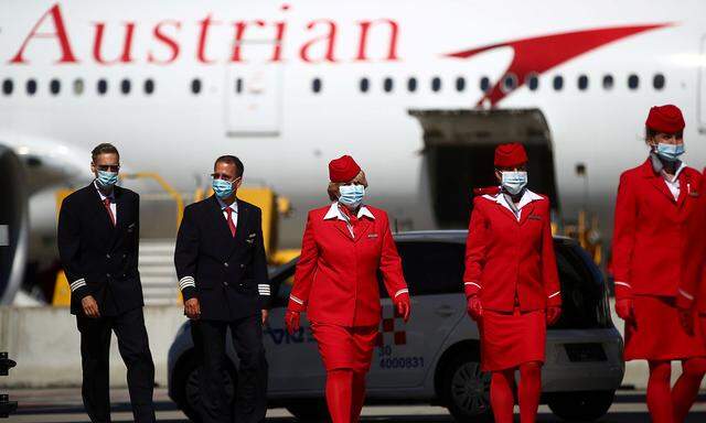 FILE PHOTO: Flight crew members of an aircraft of Lufthansa's unit Austrian Airlines are pictured ahead of take off to New York at the Vienna International Airport in Schwechat