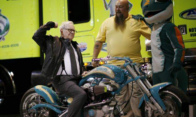 Billionaire financier and Berkshire Hathaway CEO Warren Buffett poses on a motorcycle during Berkshire Hathaway Annual Shareholders meeting in Omaha