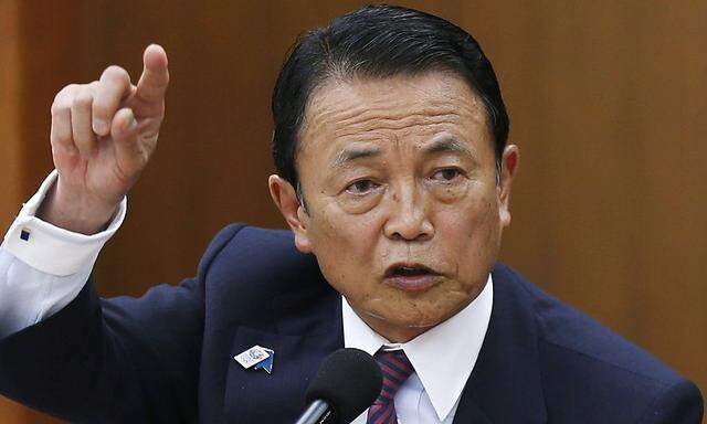 Japan's Finance Minister Taro Aso speaks during a semi-annual parliament hearing on monetary policy in Tokyo