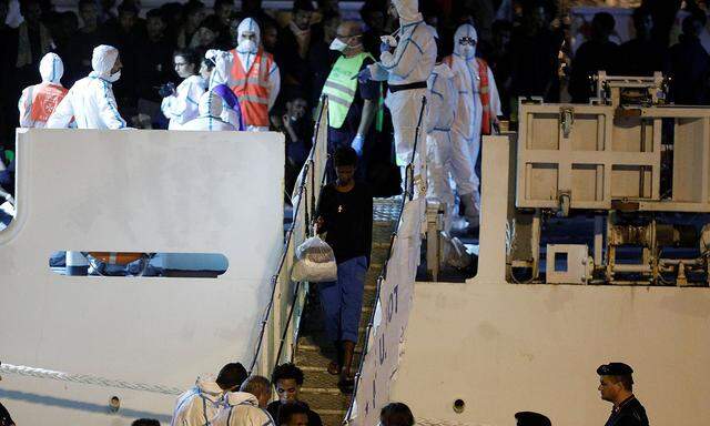 Unaccompanied minor migrants disembark from the Italian coast guard vessel 'Diciotti' at the port of Catania