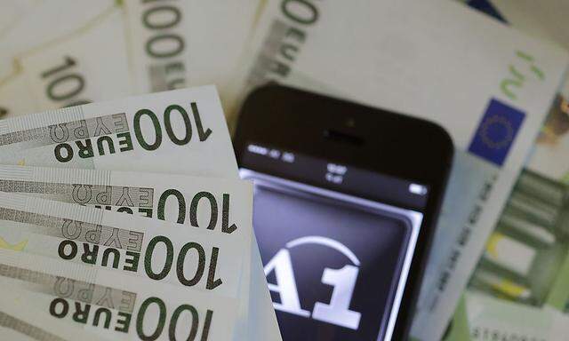A photo illustration shows the company logo of mobile phone provider A1 and some bank notes in Vienna
