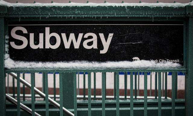 A snow covered subway sign is seen in New York's Times Square