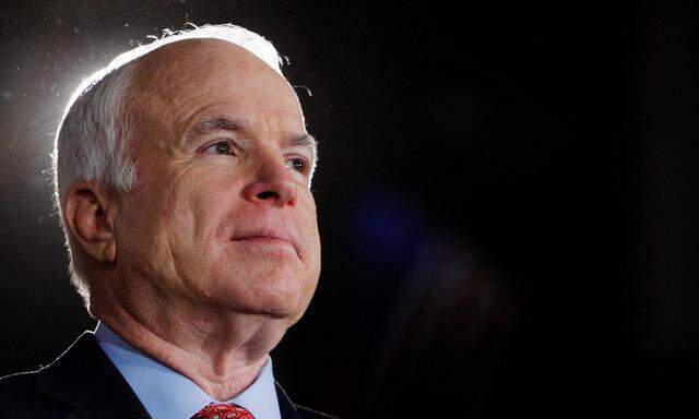 FILE PHOTO -  U.S. Republican presidential nominee Senator John McCain (R-AZ) listens during rally in Denver