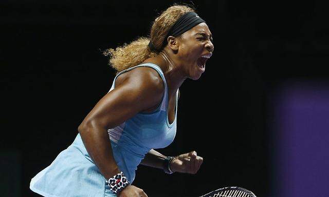 Serena Williams of the U.S. shouts as she wins a point against Caroline Wozniacki of Denmark during their WTA Finals singles semi-finals tennis match at the Singapore Indoor Stadium