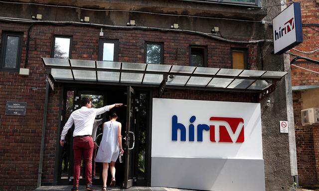 Employees of the Hungarian news television channel, Hir TV, enter the Hir TV headquarters in Budapest