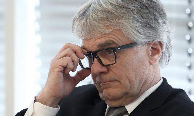 Austrian steel group Voestalpine CEO Eder adjusts his glasses during a news conference in Vienna