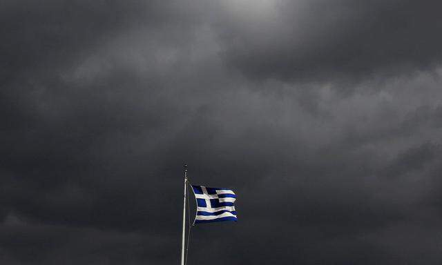 File photo of a Greek flag fluttering atop the Acropolis hill in Athens