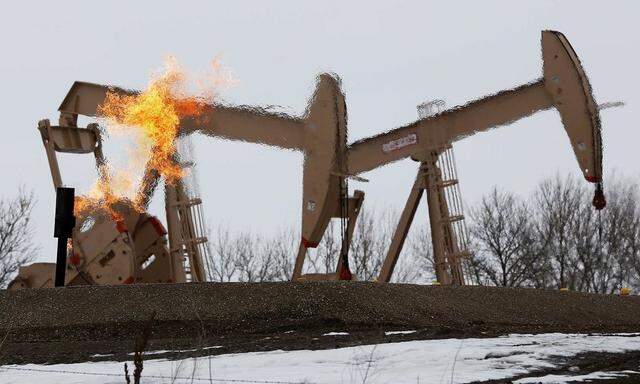 File photo of natural gas flares are seen at an oil pump site outside of Williston, North Dakota