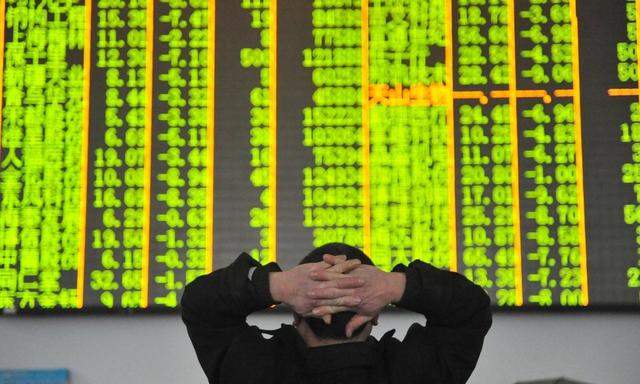 HANGZHOU CHINA JANUARY 26 CHINA OUT An investor watches the electronic board at a stock exchan