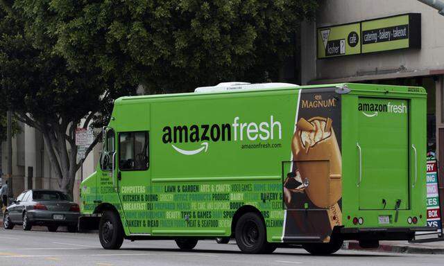 An Amazon Fresh delivery van moves down Pico Bloulevard in Los Angeles