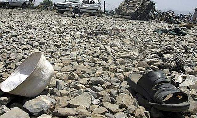 A hat and a sandal are seen at the site of a suicide blast in Khost