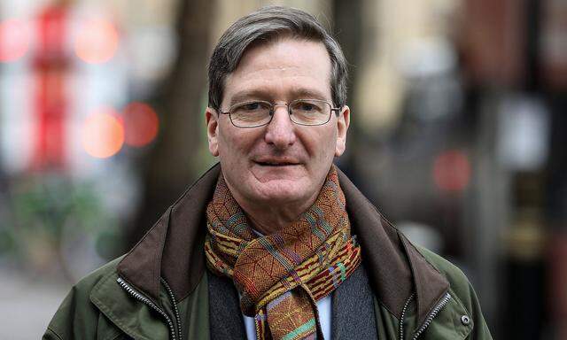 Former Attorney General Dominic Grieve looks out as he walks near the Houses of Parliament in Westminster in London