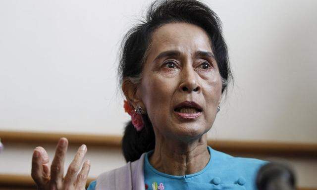 Myanmar pro-democracy and opposition leader Aung San Suu Kyi talks to reporters during her news conference at Lower House of Parliament in Naypyitaw