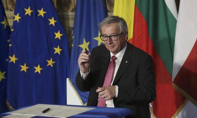 European Commission President Juncker holds up a pen after signing document during the EU leaders meeting on the 60th anniversary of the Treaty of Rome, in Rome