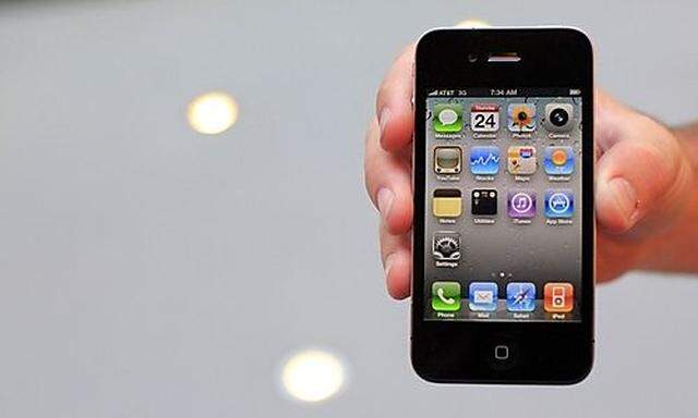 Customer displays an iPhone 4 purchased at the Apple Store 5th Avenue in New York