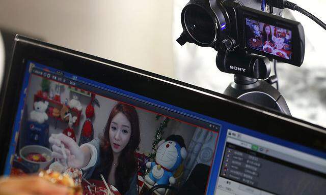 Park displays a spoonful of food for the camera during her eating show in her apartment in Incheon