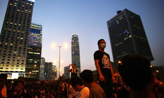 Protesters block the main street to the financial Central district, outside the government headquarters in Hong Kong