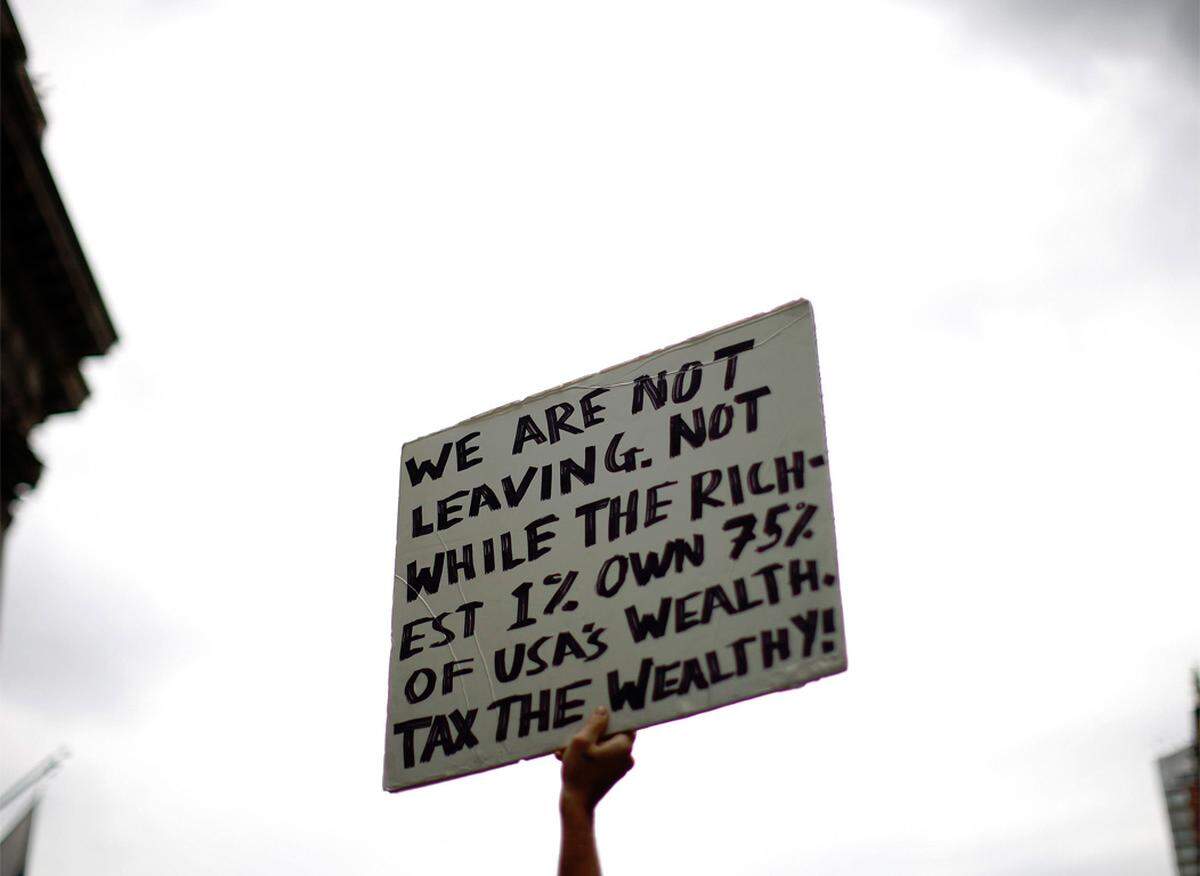"Wir gehen nicht weg", drohten sie auf Plakaten. "Besteuert die Reichen", forderten sie.