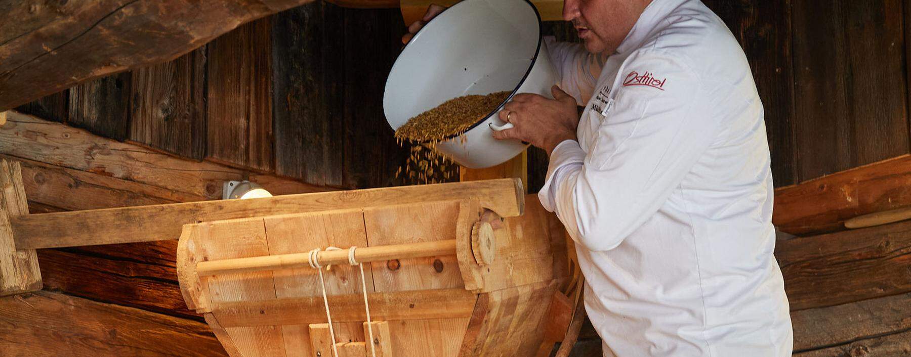 Josef Mühlmann mit seiner renovierten historischen Getreidemühle, die besonders feines Mehl (Typ 400) mahlen kann. 