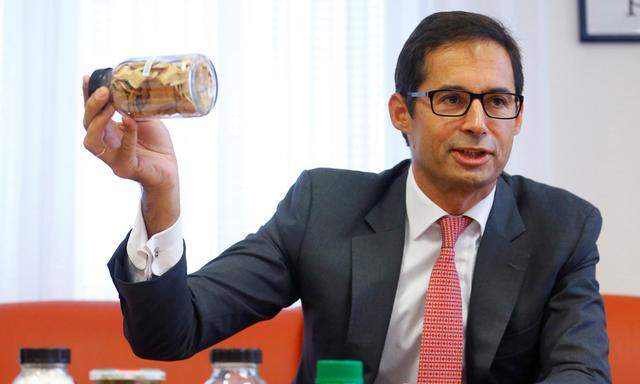 Doboczky, CEO of Austrian cellulose fibers maker Lenzing, displays botanic substances connected to Lenzing´s fibres production during a news conference in Vienna