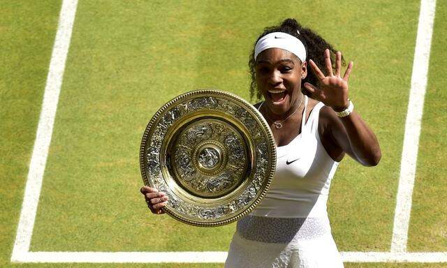 Serena Williams of the U.S.A celebrates with the trophy after winning her Women's Final match against Garbine Muguruza of Spain at the Wimbledon Tennis Championships in London