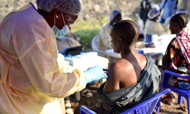 A Congolese health worker administers an ebola vaccine to a man at the Himbi Health Centre in Goma