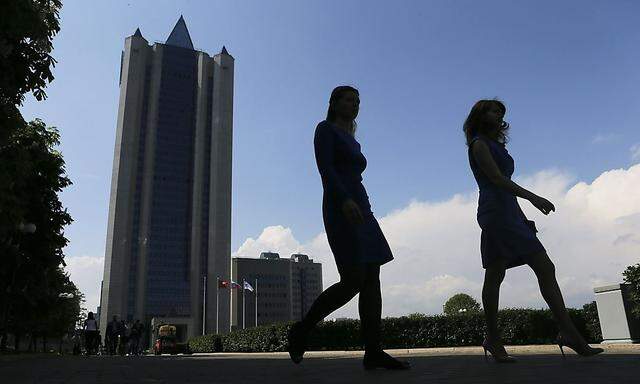 Women walk near Gazprom's main office in Moscow