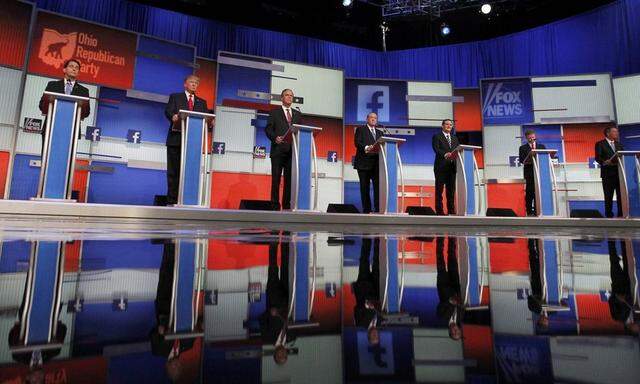 Republican 2016 presidential candidates stand at their podiums at the first official Republican presidential candidates debate of the 2016 U.S. presidential campaign in Cleveland