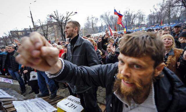 Pro-Russian protesters attend a rally in front of the seized office of the SBU state security service in Luhansk