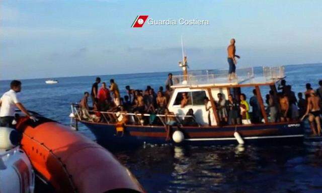 A still image taken from video released by the Italian Coastguard shows migrants rescued from the water off the southern Italian island of Lampedusa