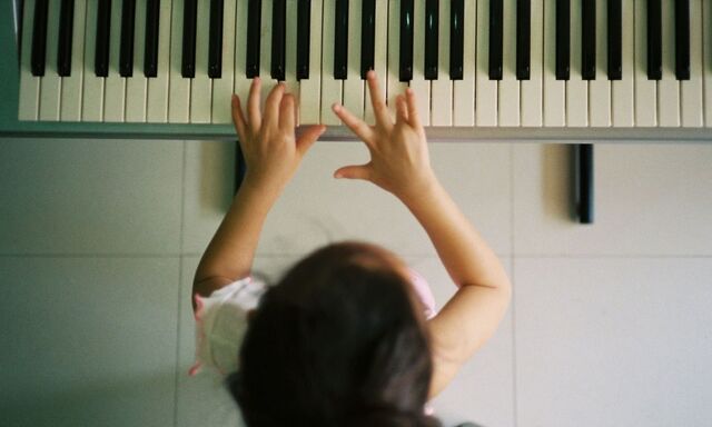 Directly Above Shot Of Girl Playing Piano At Home