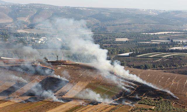 Smoke rises from shells fired from Israel in Maroun Al-Ras village, near the border with Israel, in southern Lebanon