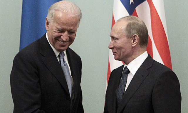 Russian Prime Minister Putin shakes hands with U.S. Vice President Biden during their meeting in Moscow